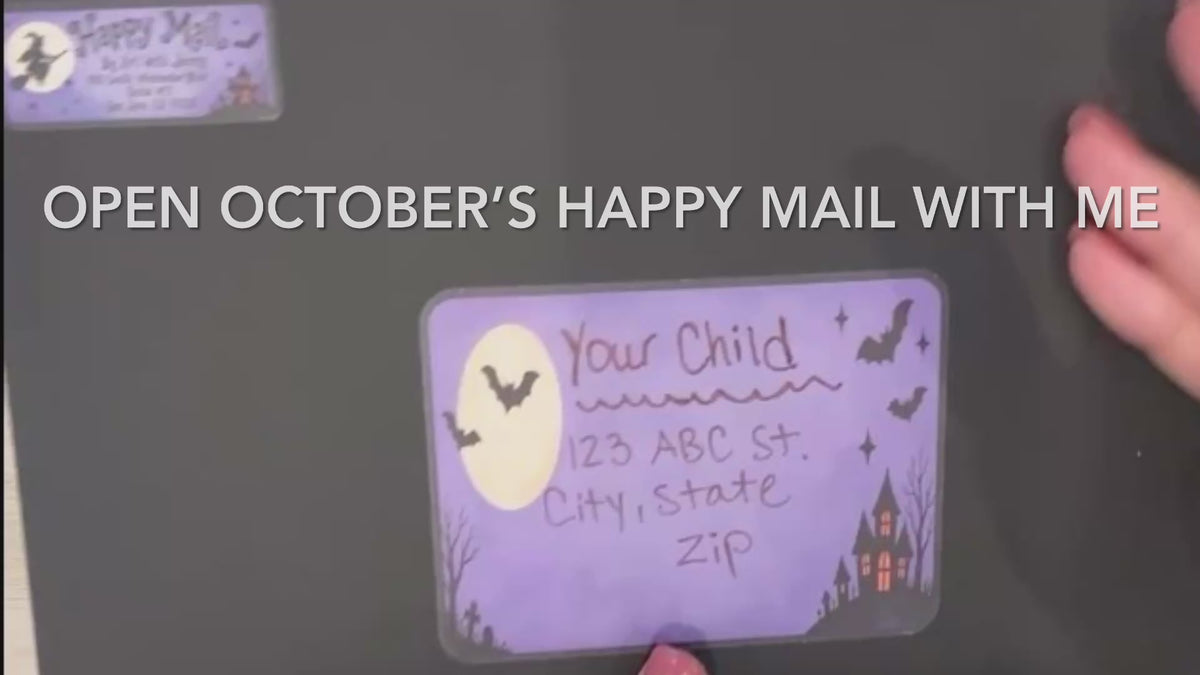 Load video: Opening October’s Halloween-themed Happy Mail envelope to reveal colorful wrapping, stickers, stencils, a little ghost friend, a rainbow scratch-art pumpkin, an art project with step-by-step instructions, and Halloween activities.